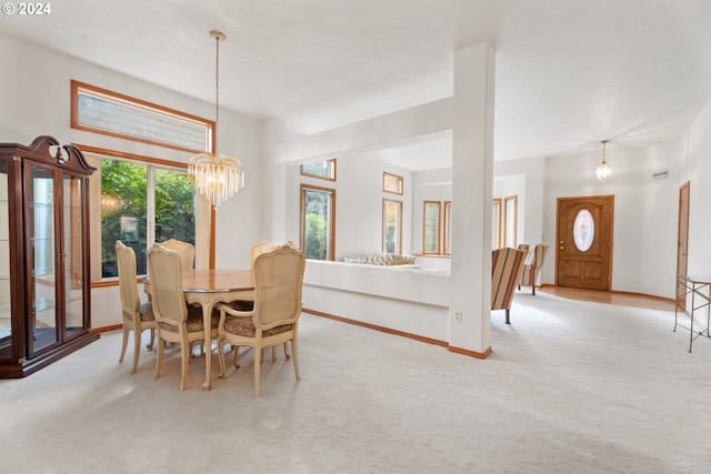 carpeted dining room featuring a chandelier and a healthy amount of sunlight