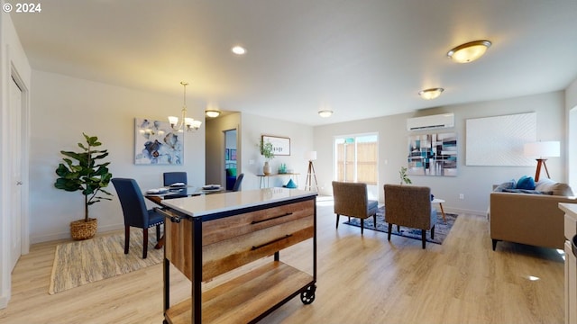 dining area featuring an inviting chandelier, light wood-type flooring, and a wall mounted air conditioner