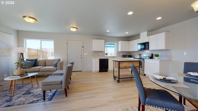 living room featuring a wealth of natural light and light hardwood / wood-style floors