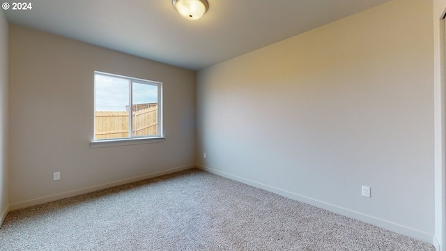 spare room with light colored carpet