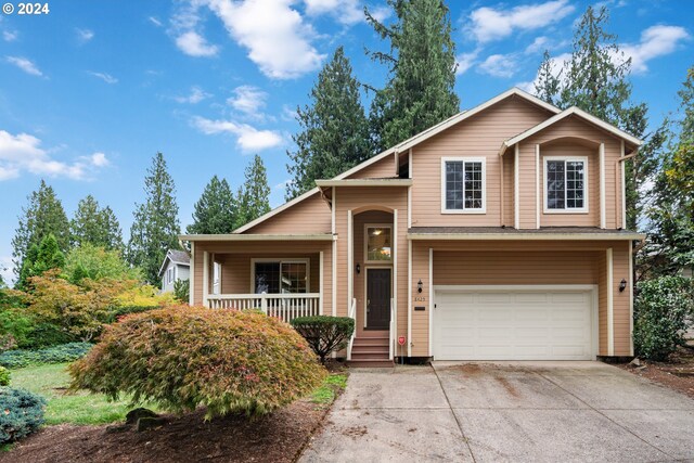 view of front of property with a porch and a garage