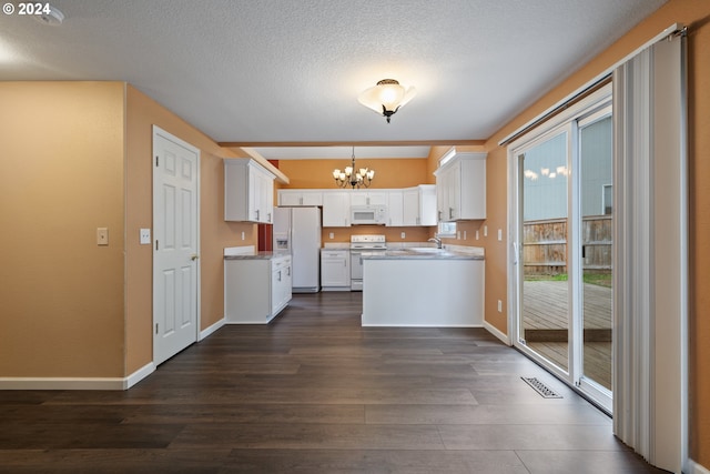 kitchen with white cabinetry, hanging light fixtures, dark hardwood / wood-style flooring, a textured ceiling, and white appliances