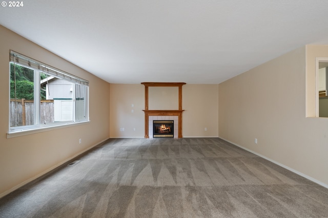 unfurnished living room with a fireplace and light colored carpet