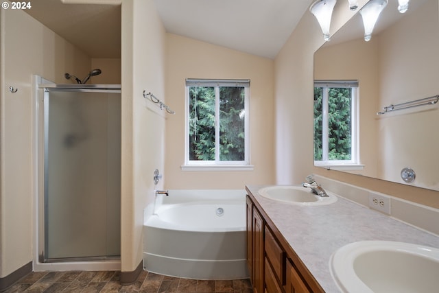 bathroom with vanity, lofted ceiling, and independent shower and bath