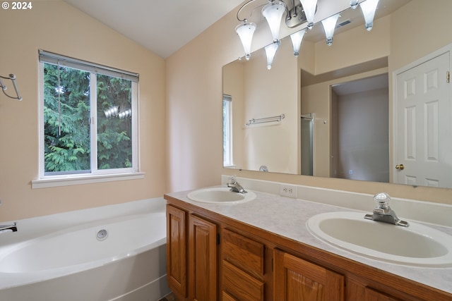 bathroom with plus walk in shower, vanity, and vaulted ceiling