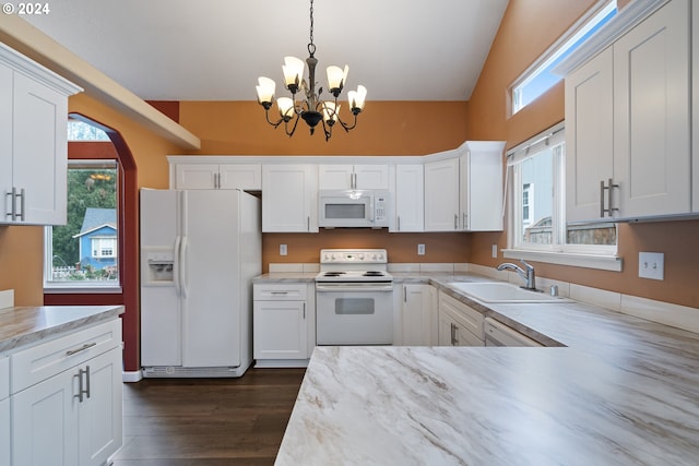 kitchen featuring dark hardwood / wood-style flooring, white appliances, sink, white cabinets, and hanging light fixtures