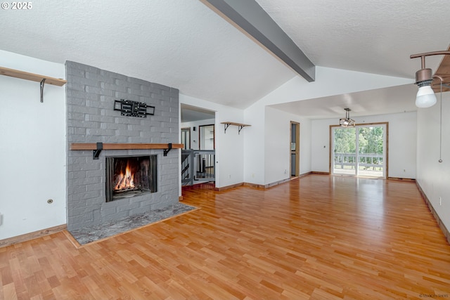 1504 SW 24th St, Troutdale, OR 97060 - unfurnished living room featuring wood finished floors, a fireplace, a textured ceiling, and baseboards