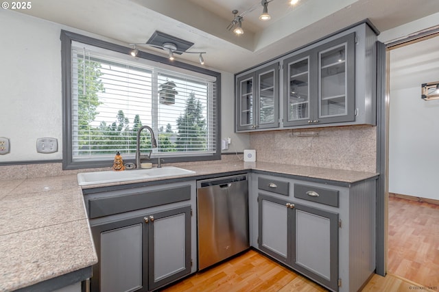 1504 SW 24th St, Troutdale, OR 97060 - kitchen with stainless steel dishwasher, gray cabinets, a sink, and glass insert cabinets