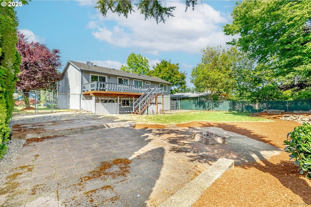 1504 SW 24th St, Troutdale, OR 97060 - back of property with an outdoor fire pit, a wooden deck, stairs, a patio, and a gate