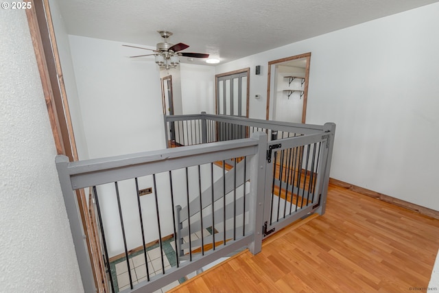 1504 SW 24th St, Troutdale, OR 97060 - corridor with an upstairs landing, wood finished floors, and a textured ceiling