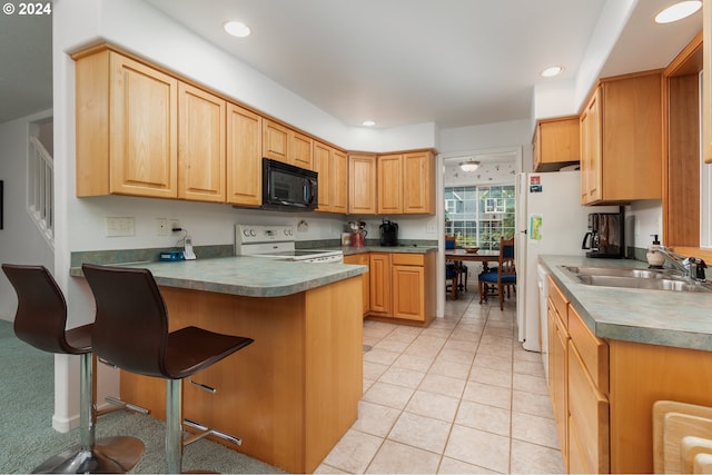 kitchen featuring light brown cabinetry, sink, a breakfast bar area, light tile patterned floors, and white appliances