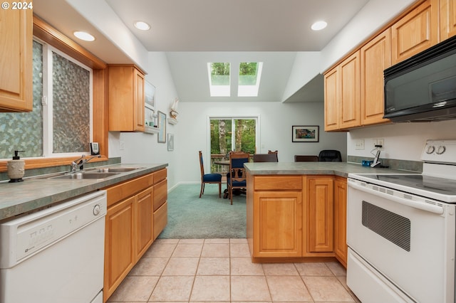 kitchen with lofted ceiling, sink, white appliances, light tile patterned floors, and kitchen peninsula