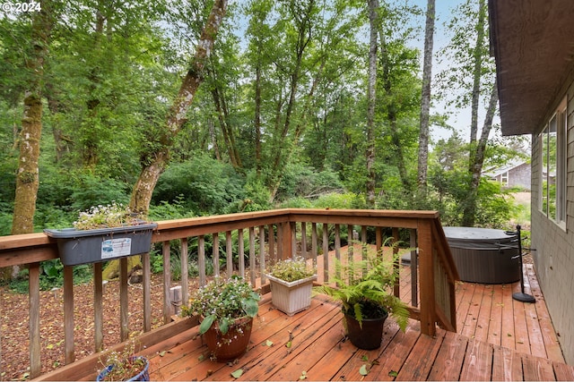 wooden deck with a hot tub