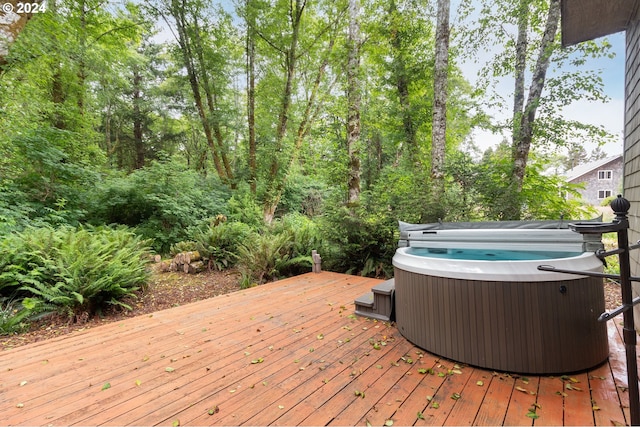 wooden deck with a hot tub