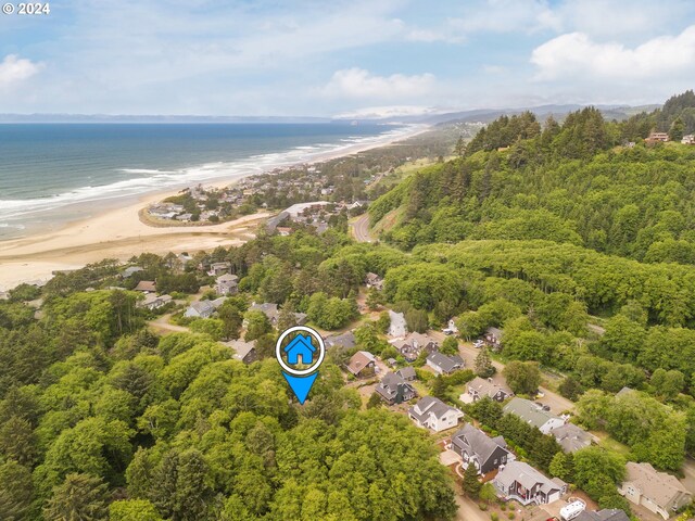 drone / aerial view featuring a water view and a beach view