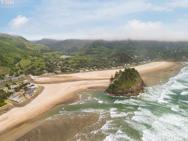 bird's eye view featuring a water view and a beach view