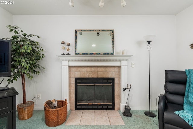 living room featuring a tiled fireplace