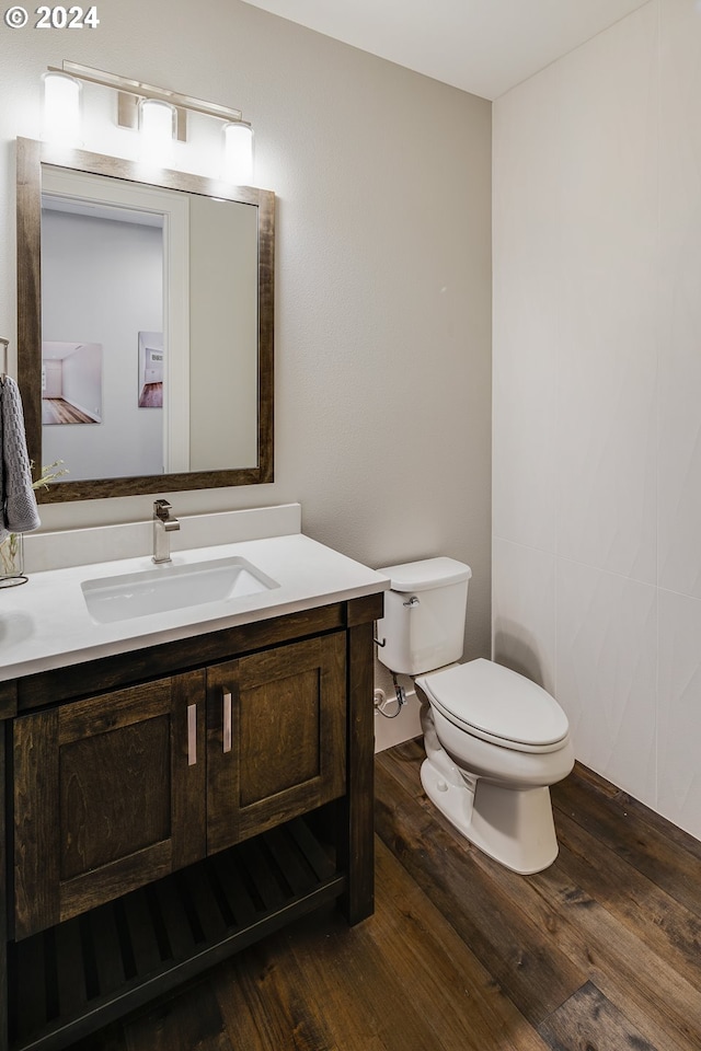 bathroom featuring vanity, hardwood / wood-style flooring, and toilet