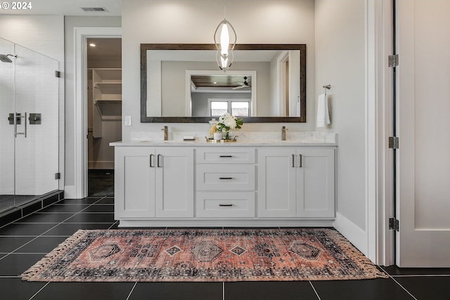 bathroom featuring vanity, an enclosed shower, and tile patterned flooring