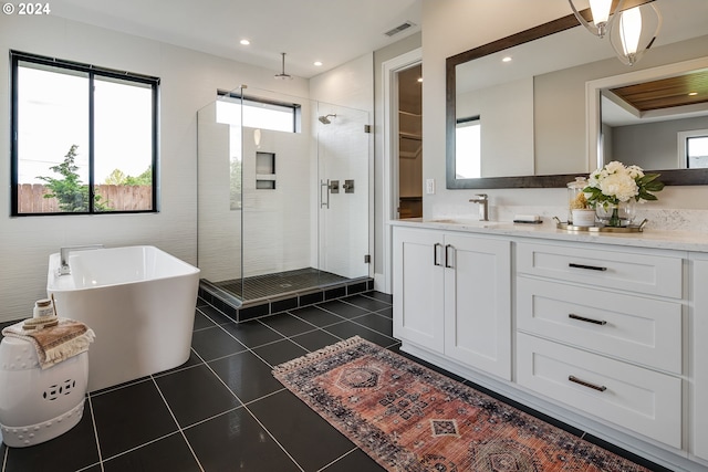 bathroom featuring vanity, plus walk in shower, and tile patterned flooring