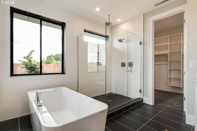 bathroom featuring tile patterned flooring and plus walk in shower