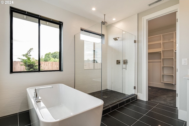 bathroom featuring tile patterned flooring and plus walk in shower