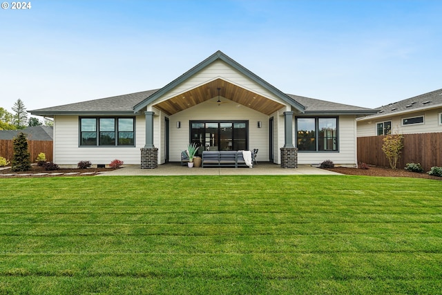 back of house with an outdoor hangout area, a lawn, and a patio