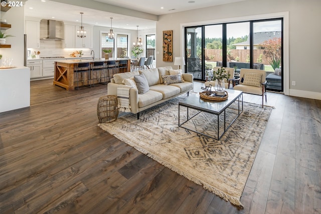 living room featuring dark hardwood / wood-style floors and a chandelier