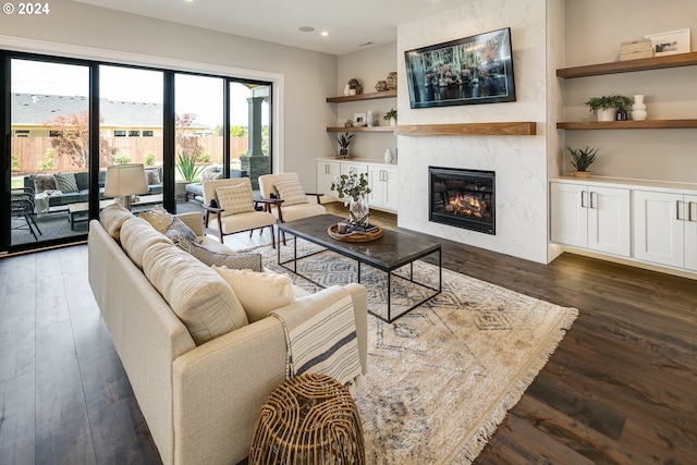 living room featuring dark wood-type flooring and a fireplace