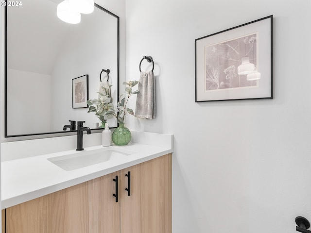 bathroom featuring vanity and vaulted ceiling