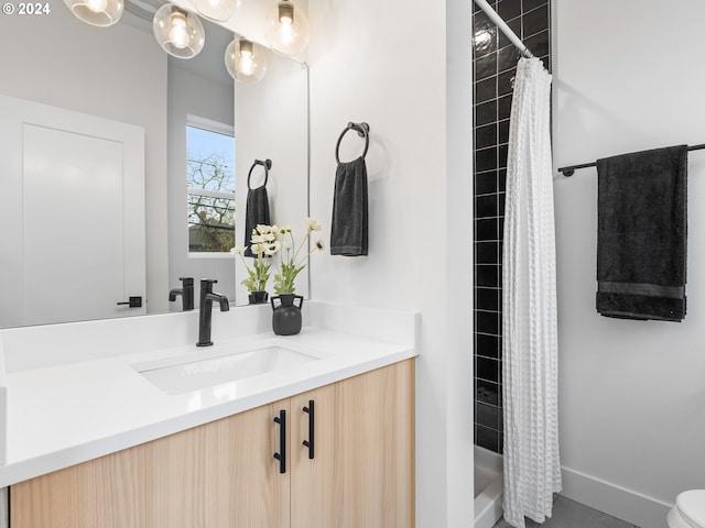 bathroom featuring vanity, toilet, and walk in shower