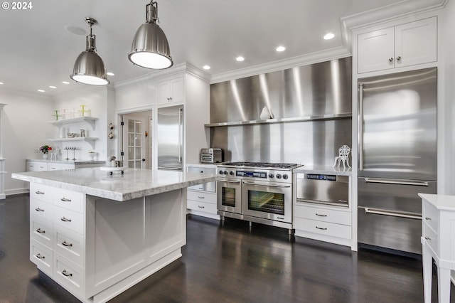 kitchen featuring white cabinetry, dark hardwood / wood-style floors, a center island, and high end appliances