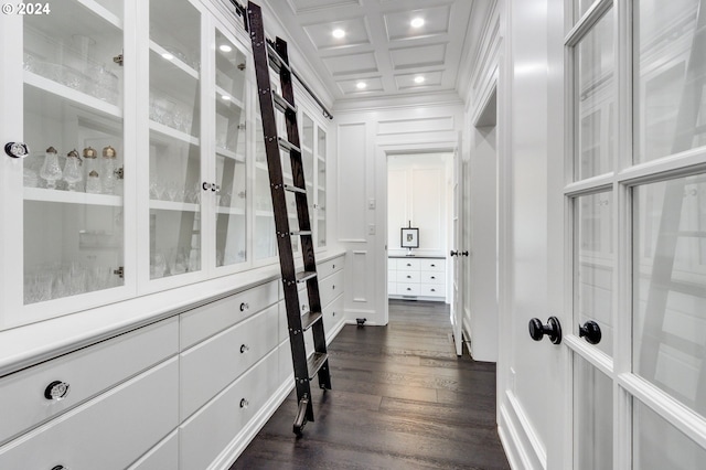 walk in closet featuring dark hardwood / wood-style flooring, coffered ceiling, and beamed ceiling