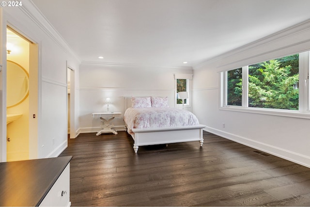 bedroom featuring ornamental molding, dark hardwood / wood-style flooring, and ensuite bathroom