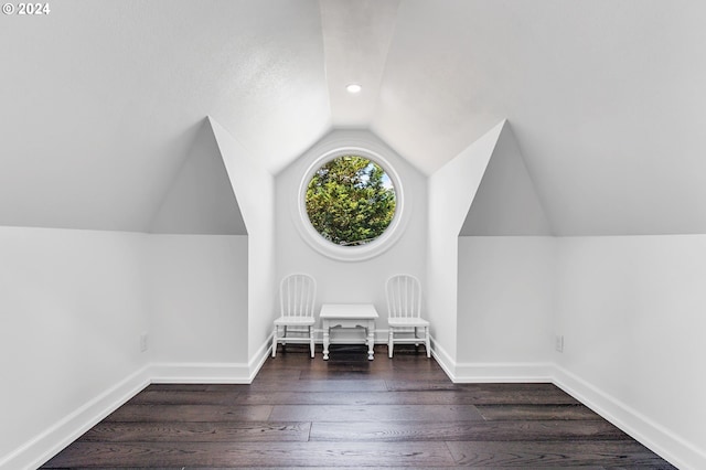 bonus room with dark hardwood / wood-style floors and lofted ceiling