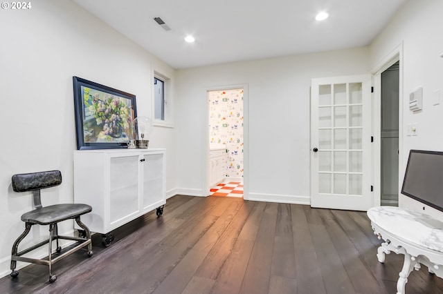 sitting room featuring dark wood-type flooring