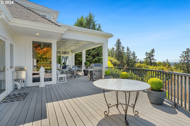 wooden deck featuring area for grilling