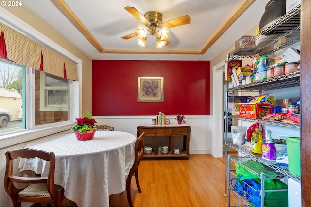 dining room featuring wood-type flooring, a textured ceiling, and ceiling fan