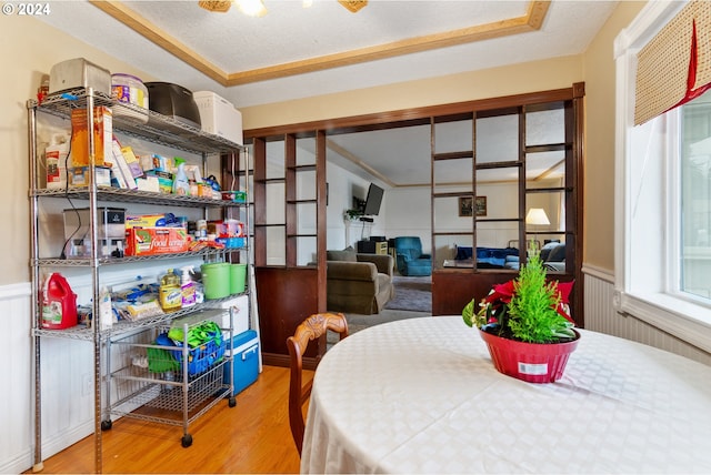 dining space with hardwood / wood-style floors and a textured ceiling