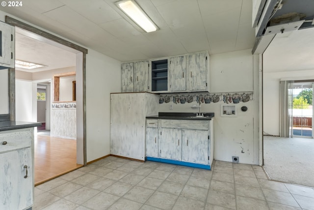 kitchen featuring light colored carpet