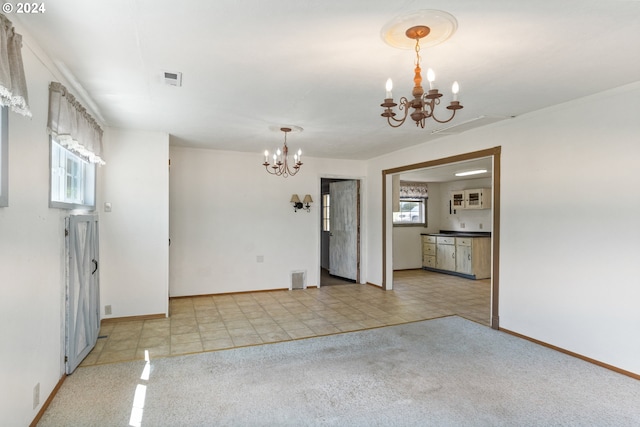 unfurnished room with light carpet and an inviting chandelier