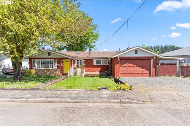 single story home with a garage and a front lawn