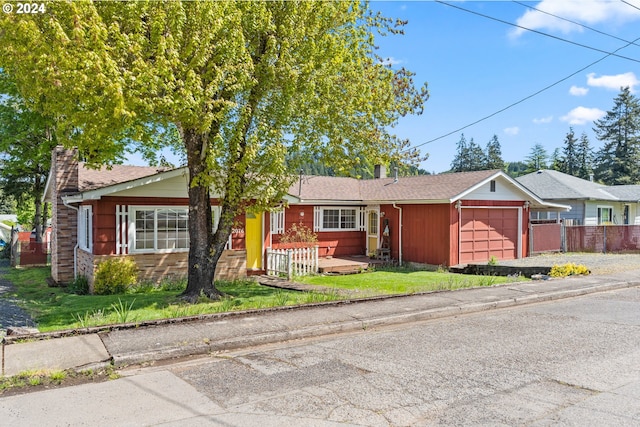 single story home with a front yard and a garage