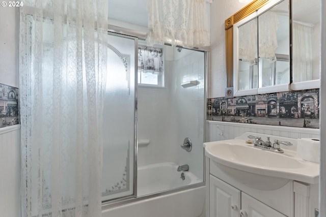 bathroom featuring backsplash, tiled shower / bath, and large vanity