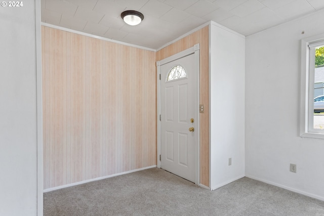 view of carpeted foyer entrance