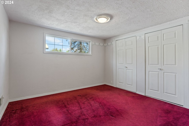 unfurnished bedroom featuring a closet, carpet, and a textured ceiling