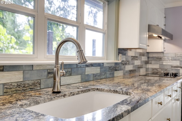 kitchen featuring white cabinetry, plenty of natural light, and sink