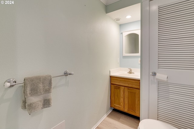 bathroom featuring vanity, toilet, and hardwood / wood-style flooring