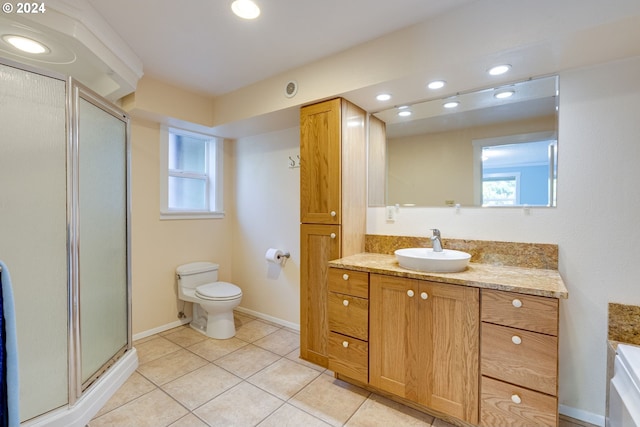 bathroom with walk in shower, vanity, toilet, and tile patterned floors