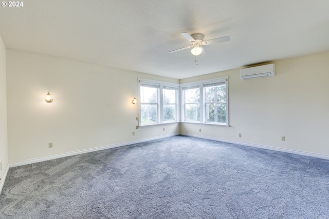 carpeted spare room featuring ceiling fan and a wall mounted air conditioner